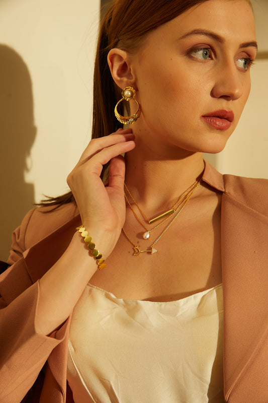 A glimmer of shimmer embelished golden earrings.