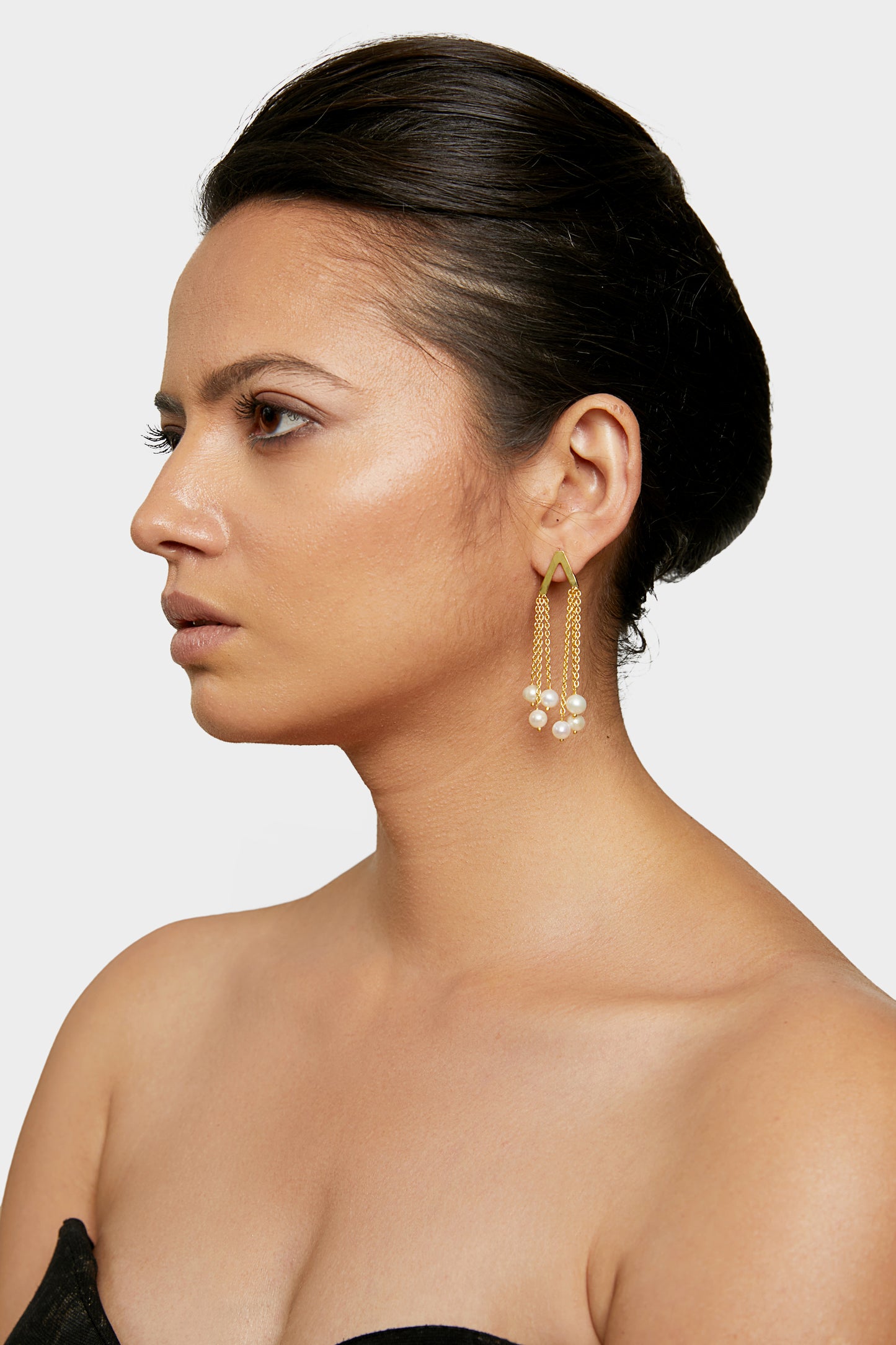 an elegant delight golden pearl tassel earrings.