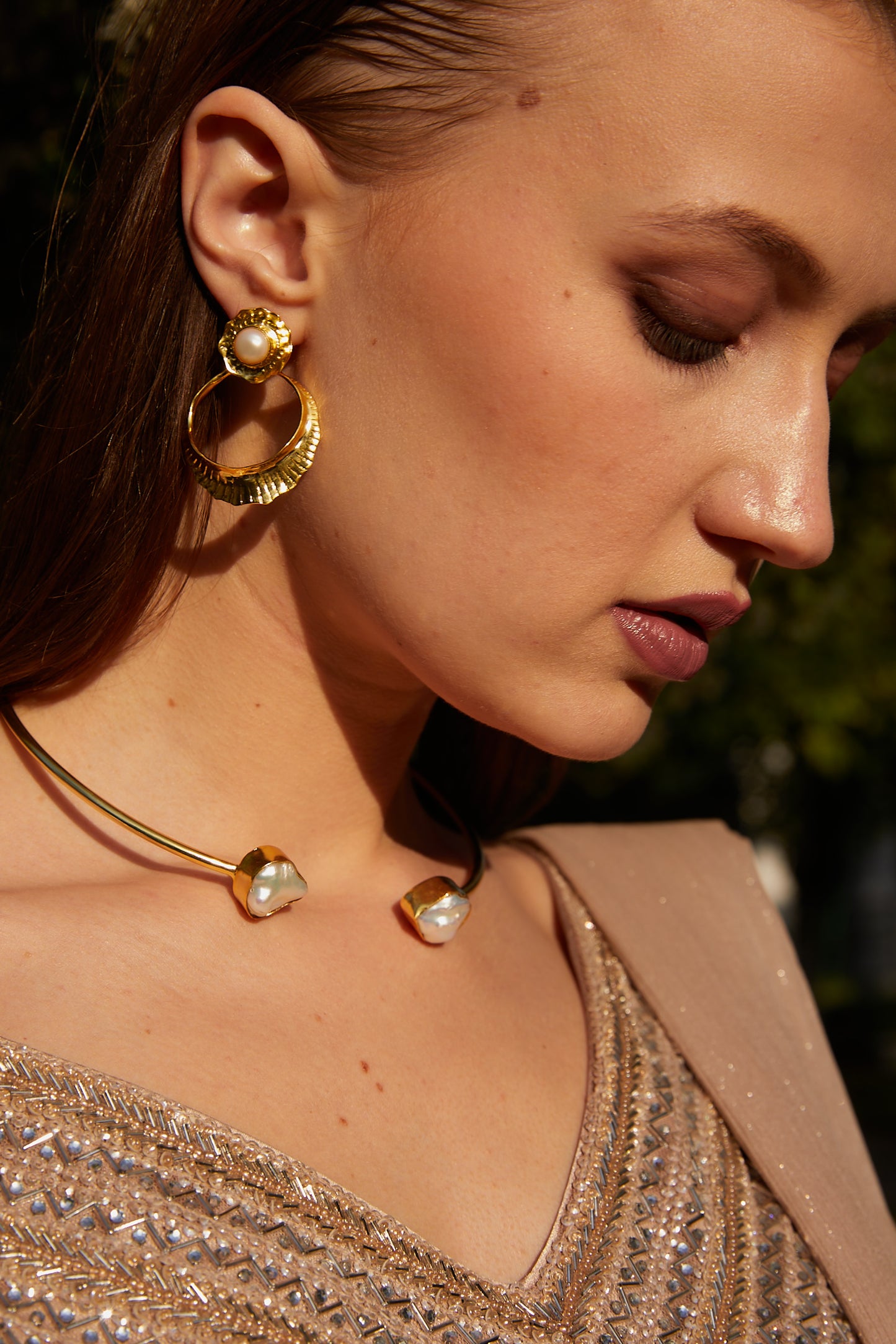A glimmer of shimmer embelished golden earrings.