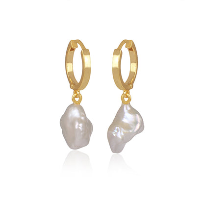 the subtle affirmation golden hoop pearl earrings