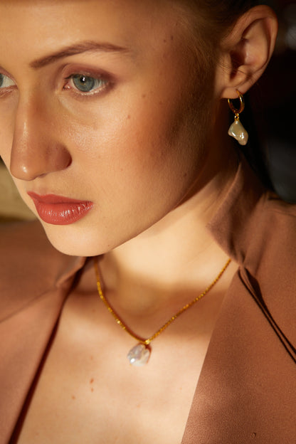 the subtle affirmation golden hoop pearl earrings