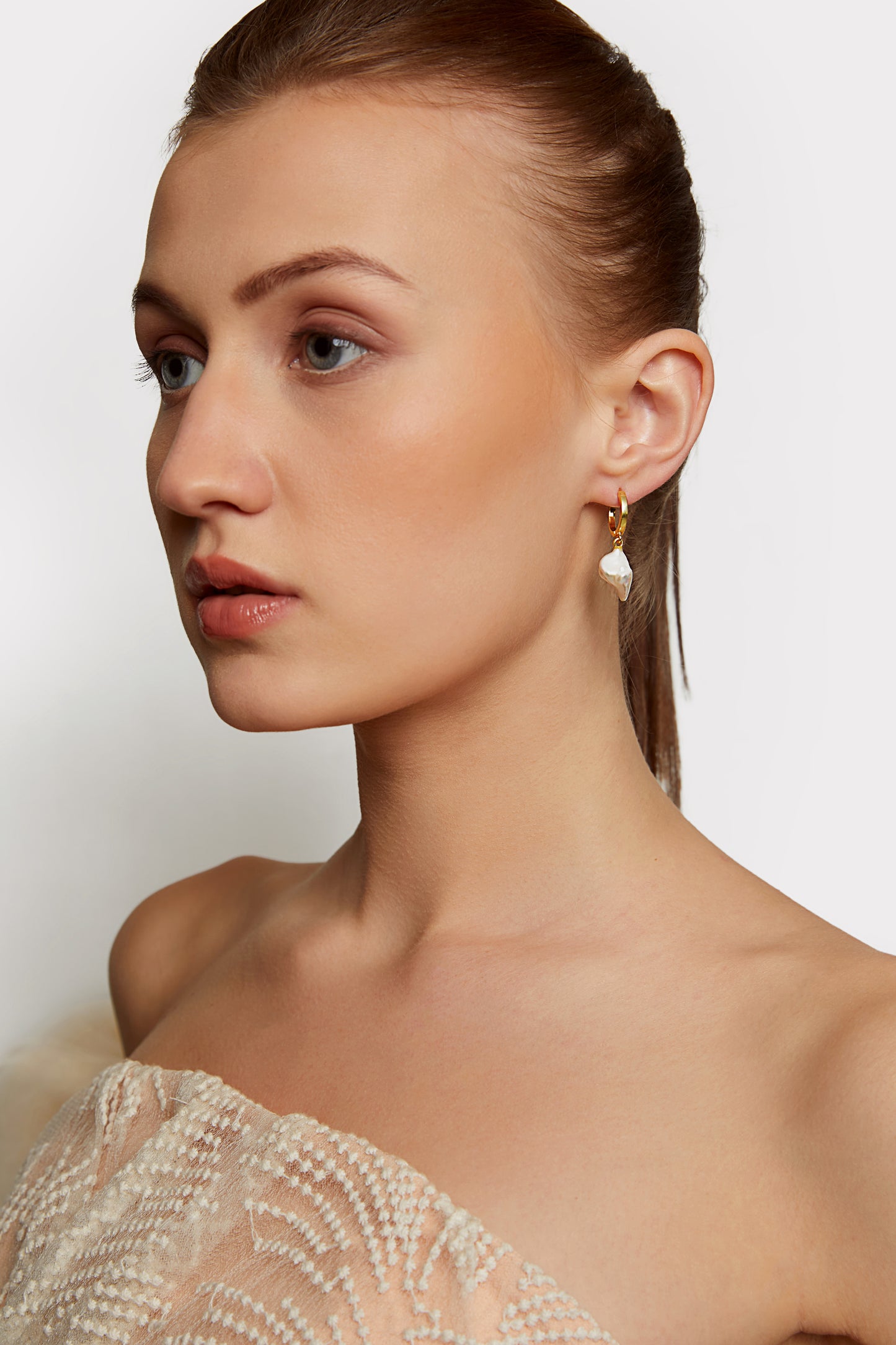 the subtle affirmation golden hoop pearl earrings